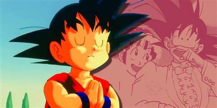 Goku is putting his hands into fists and standing in front of fire.