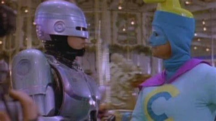 RoboCop shaking hands with Commander Cash